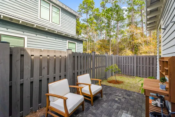 a view of a chairs in back yard of the house