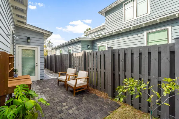 a backyard of a house with a garden and outdoor seating