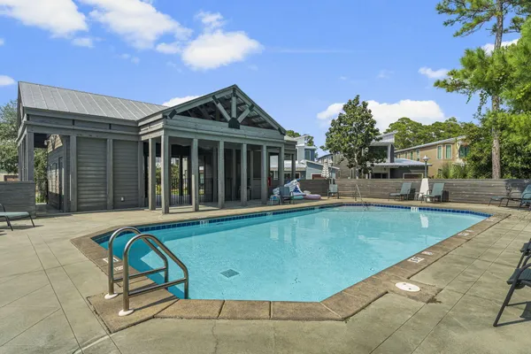a view of a house with swimming pool and sitting area