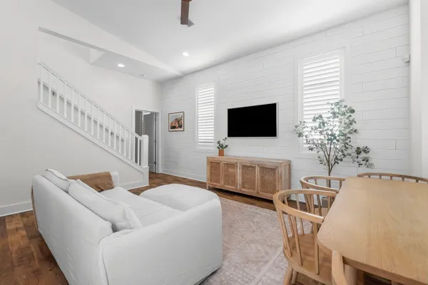 a living room with furniture and a flat screen tv