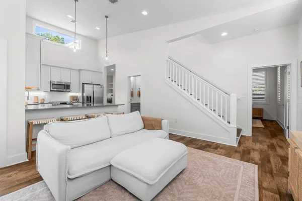a living room with furniture and a dining table