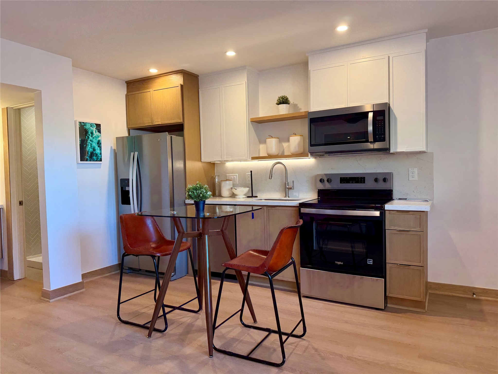 a kitchen with stainless steel appliances a refrigerator and a stove top oven