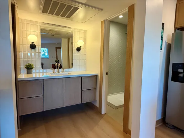 a bathroom with a sink and a mirror