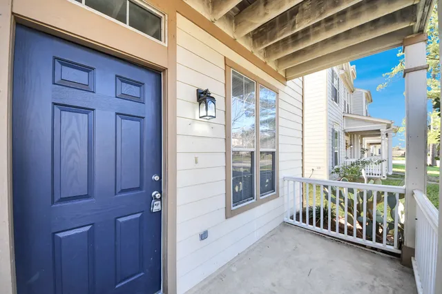 a view of a porch with a table and chairs