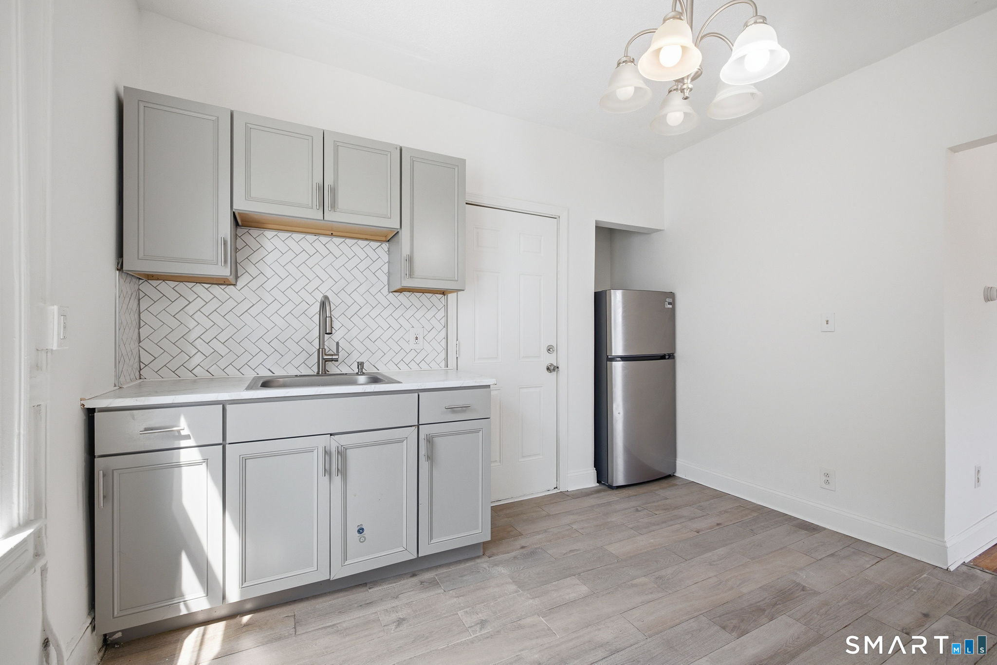 115 Baltimore Street, Unit 2 Hartford, CT 06112 - Photo 5 of 14 a kitchen with stainless steel appliances a refrigerator sink and cabinets