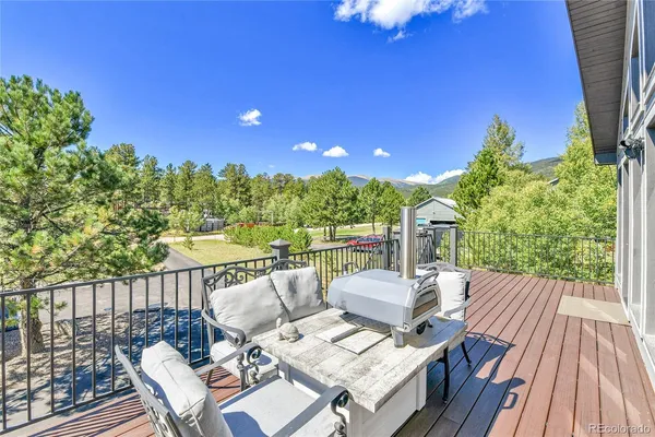 a view of balcony with wooden floor and outdoor seating