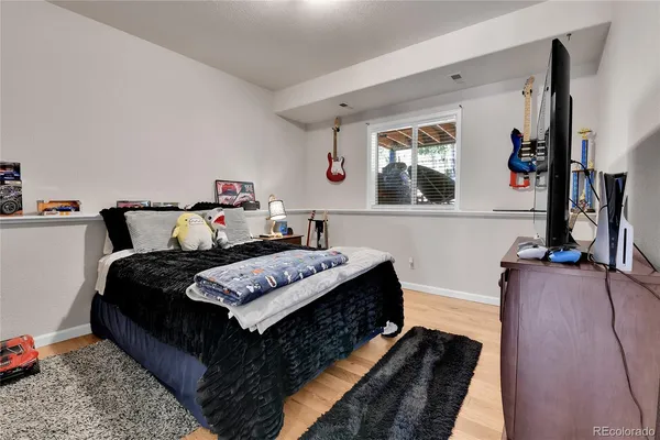 a bed sitting in a bedroom next to a window