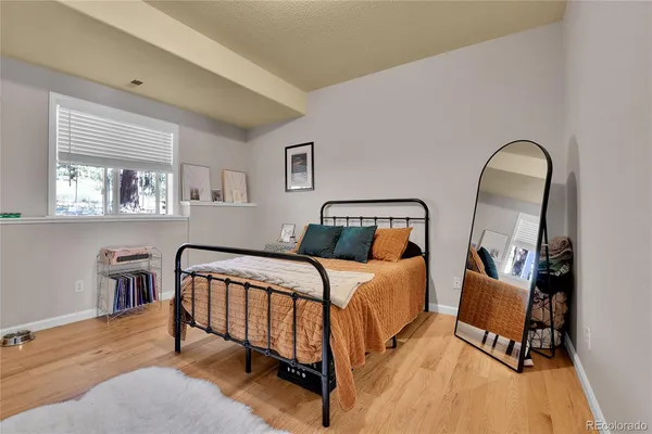 a bedroom with two beds and wooden floor