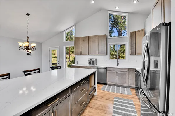 a kitchen with kitchen island a refrigerator stove and microwave