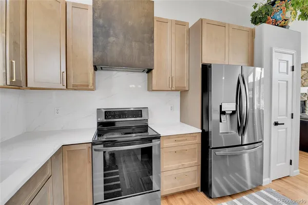 a kitchen with a refrigerator sink and cabinets