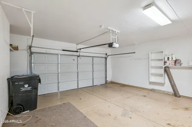 an empty room with wooden floor and hallway