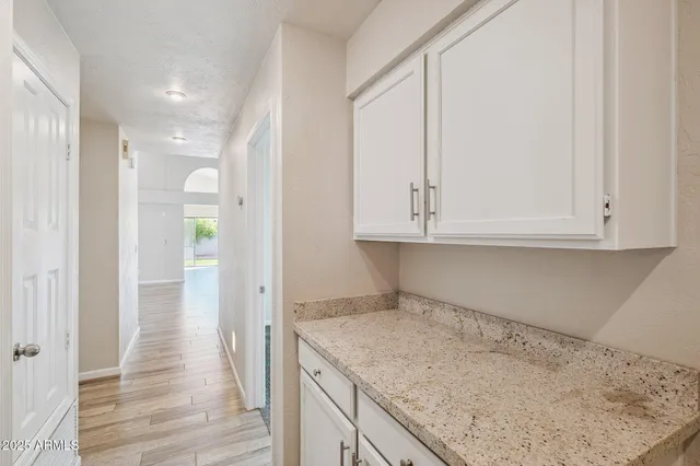 an empty room with windows and closet