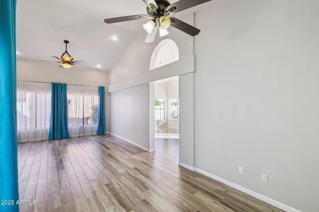 a kitchen with stainless steel appliances granite countertop a kitchen island hardwood floor sink and stove