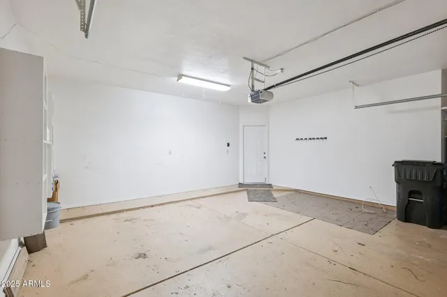 an empty room with closet and a ceiling fan