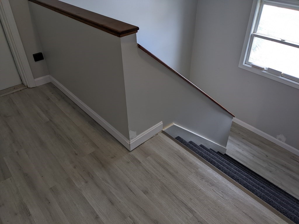 511 Buffinton Street, Unit A Fall River, MA 02721 - Photo 13 of 15 a view of wooden floor in an empty room