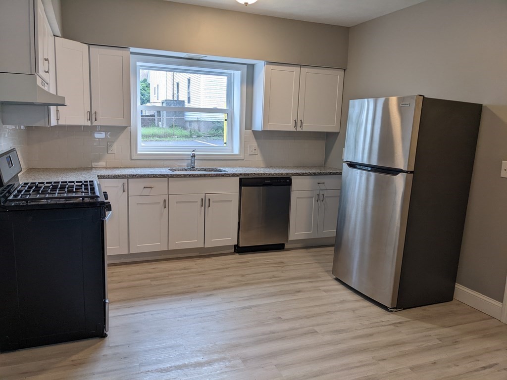 511 Buffinton Street, Unit A Fall River, MA 02721 - Photo 6 of 15 a kitchen with a refrigerator and a stove