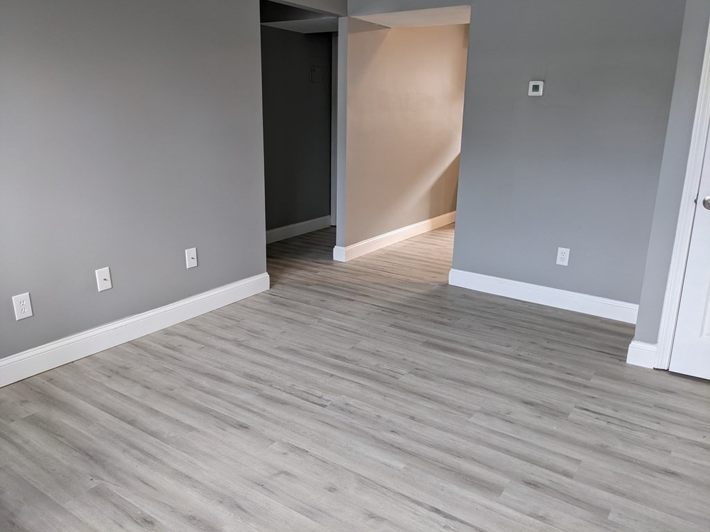 511 Buffinton Street, Unit A Fall River, MA 02721 - Photo 7 of 15 a view of an empty room with wooden floor