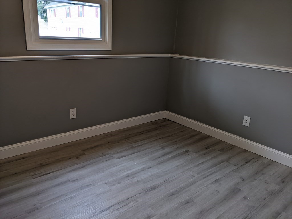 511 Buffinton Street, Unit A Fall River, MA 02721 - Photo 8 of 15 a view of a small space with wooden floor and a window