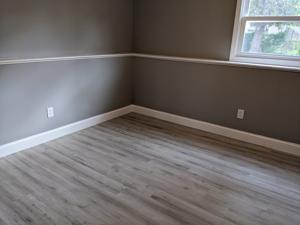 511 Buffinton Street, Unit A Fall River, MA 02721 - Photo 10 of 15 a view of an empty room with wooden floor and a window