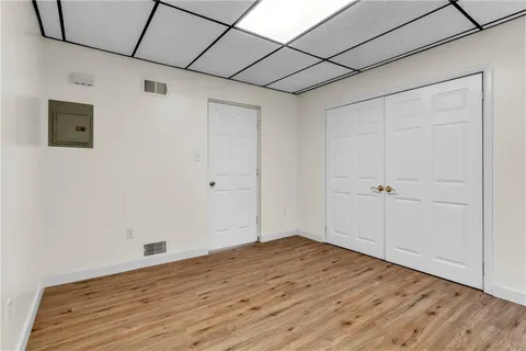 a view of empty room with wooden floor