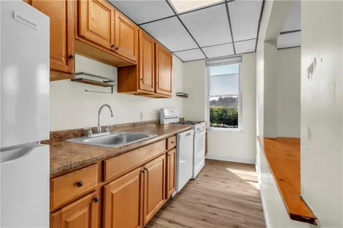 a kitchen with stainless steel appliances granite countertop a sink stove and cabinets
