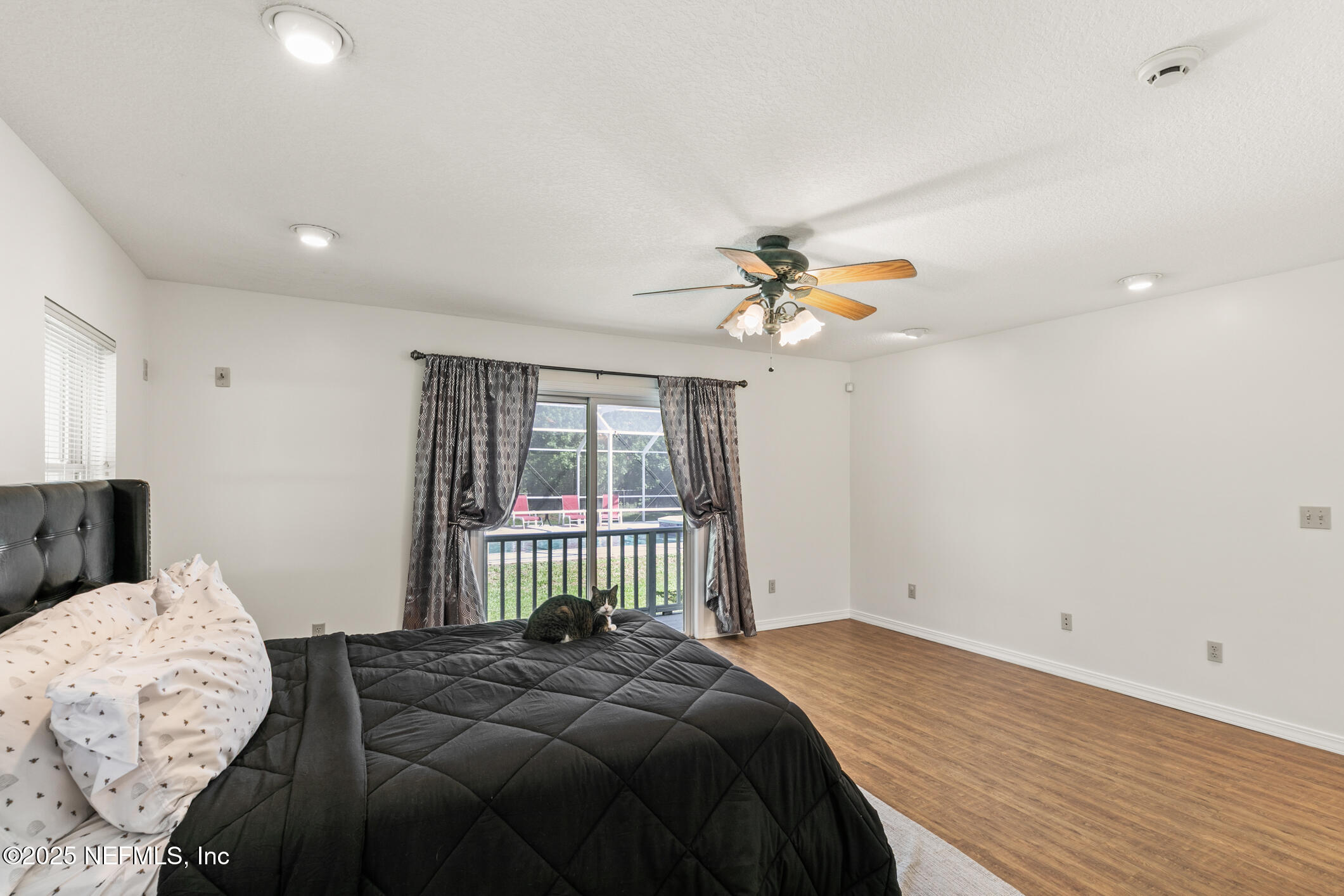 120 Stokes Landing Road St. Augustine, FL 32095 - Photo 15 of 78 a bedroom with a bed and a chandelier