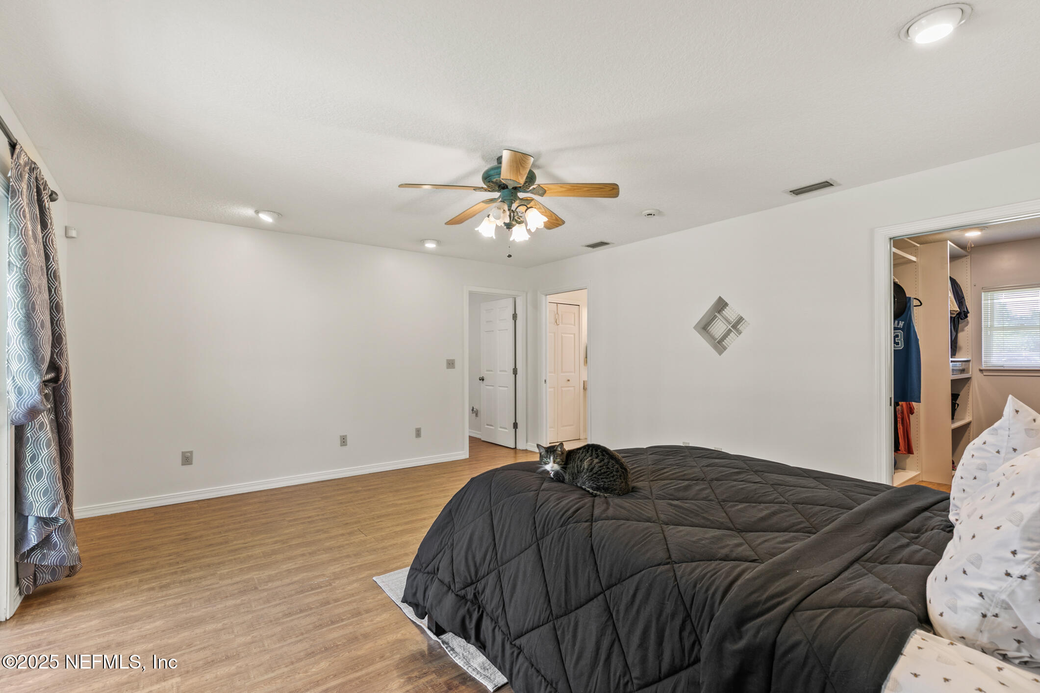 120 Stokes Landing Road St. Augustine, FL 32095 - Photo 20 of 78 a bedroom with a bed and a ceiling fan