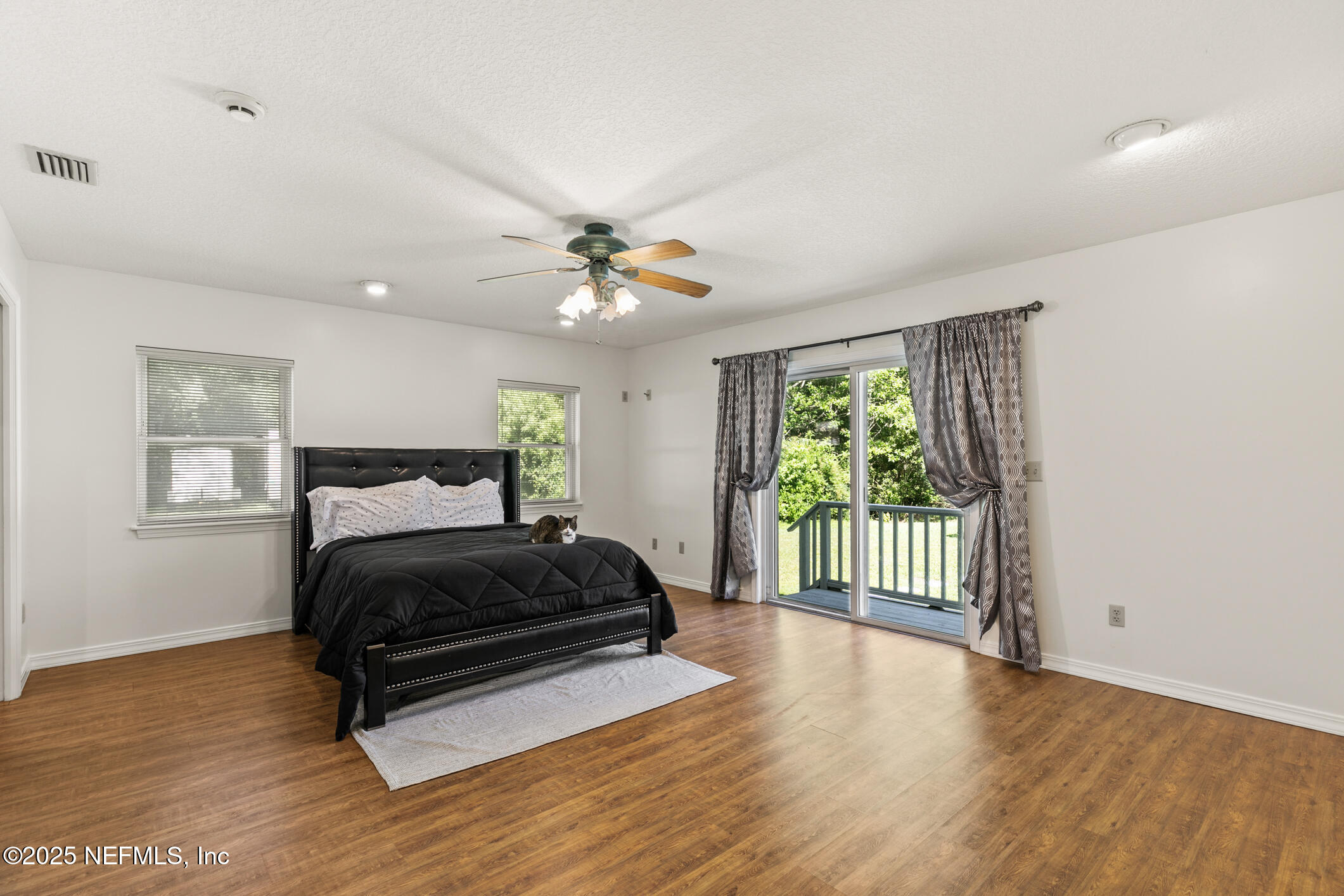 120 Stokes Landing Road St. Augustine, FL 32095 - Photo 21 of 78 a bedroom with a bed and wooden floor