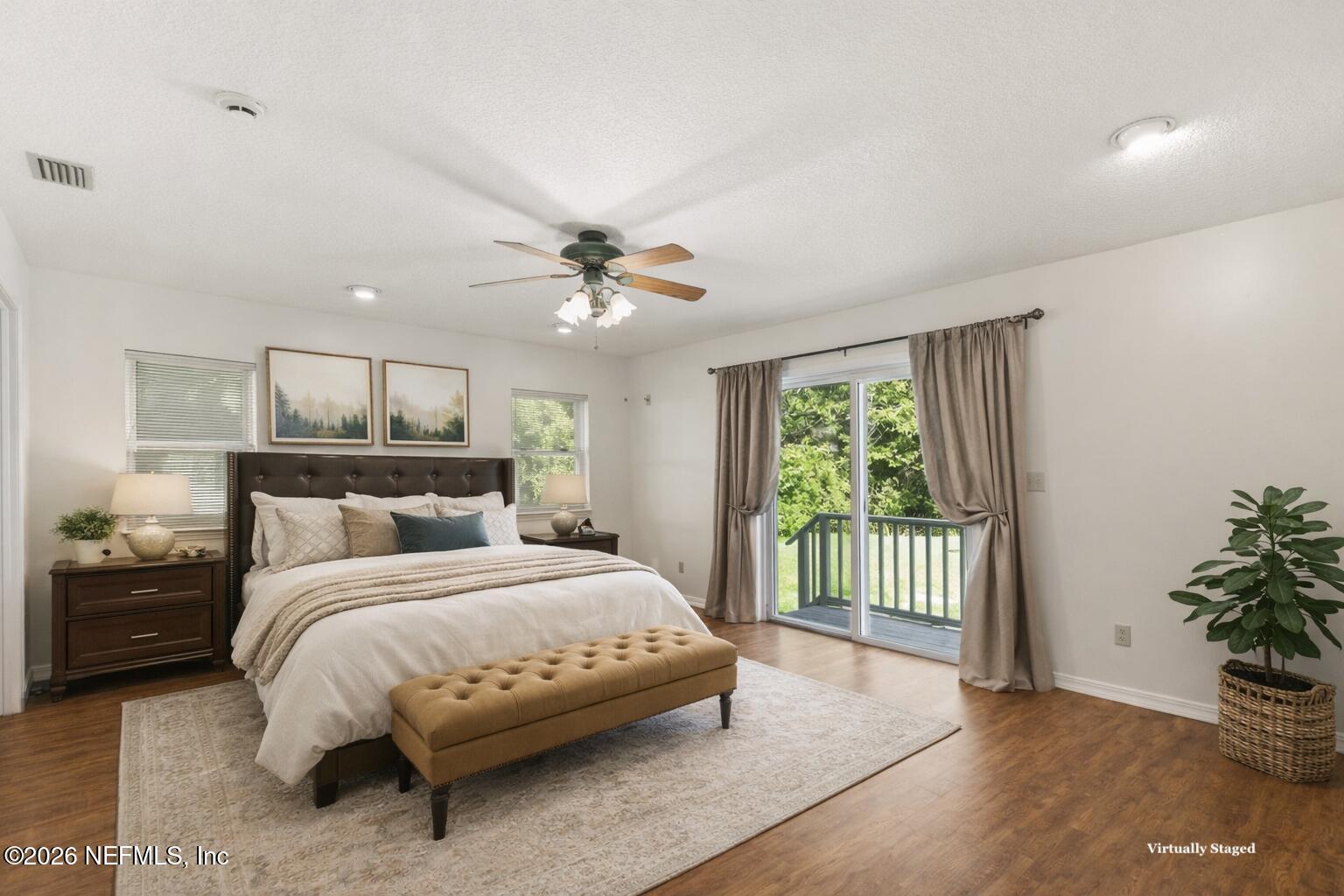 120 Stokes Landing Road St. Augustine, FL 32095 - Photo 22 of 78 a bedroom with a balcony a bed and a chandelier