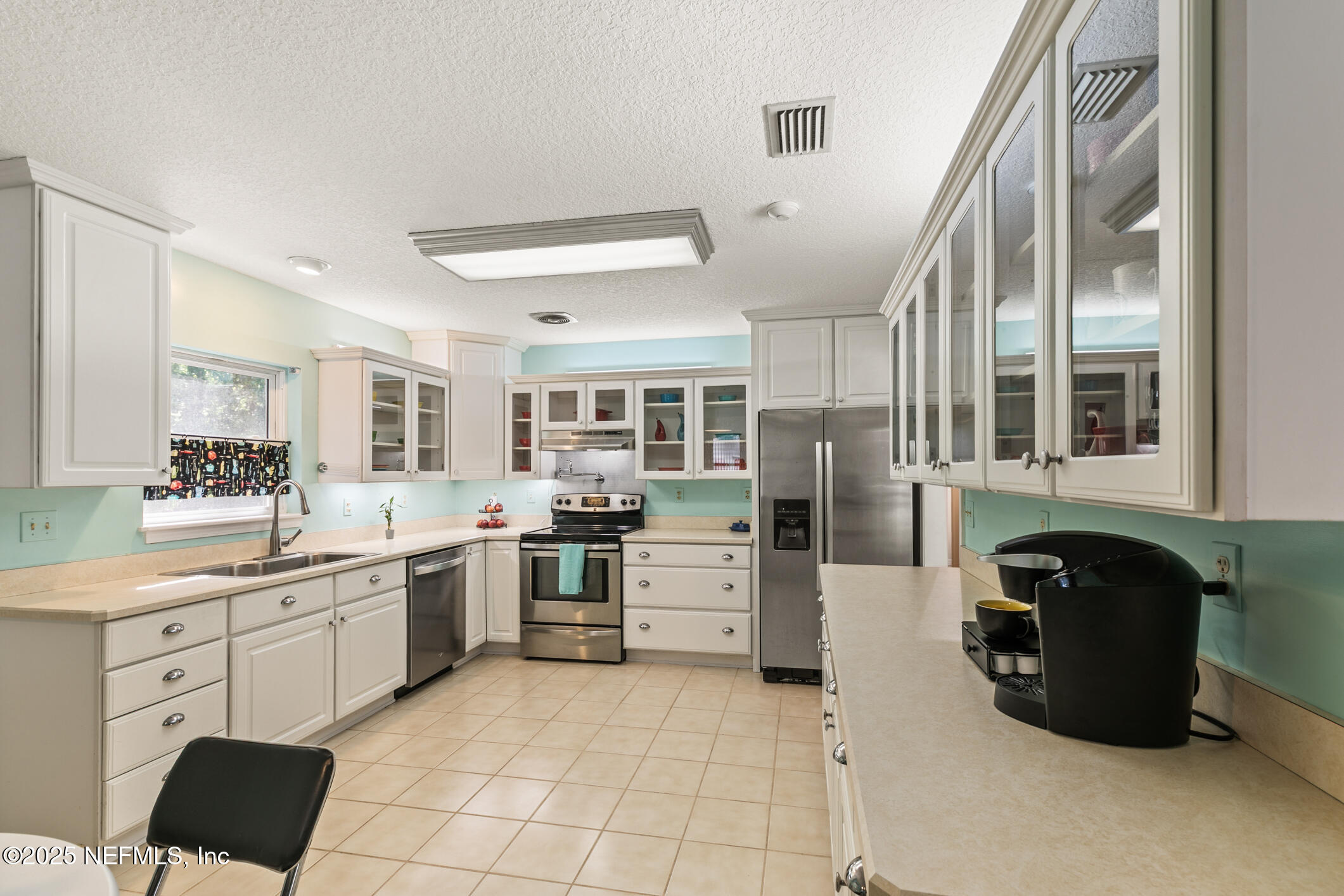 120 Stokes Landing Road St. Augustine, FL 32095 - Photo 25 of 78 a kitchen with cabinets and chairs