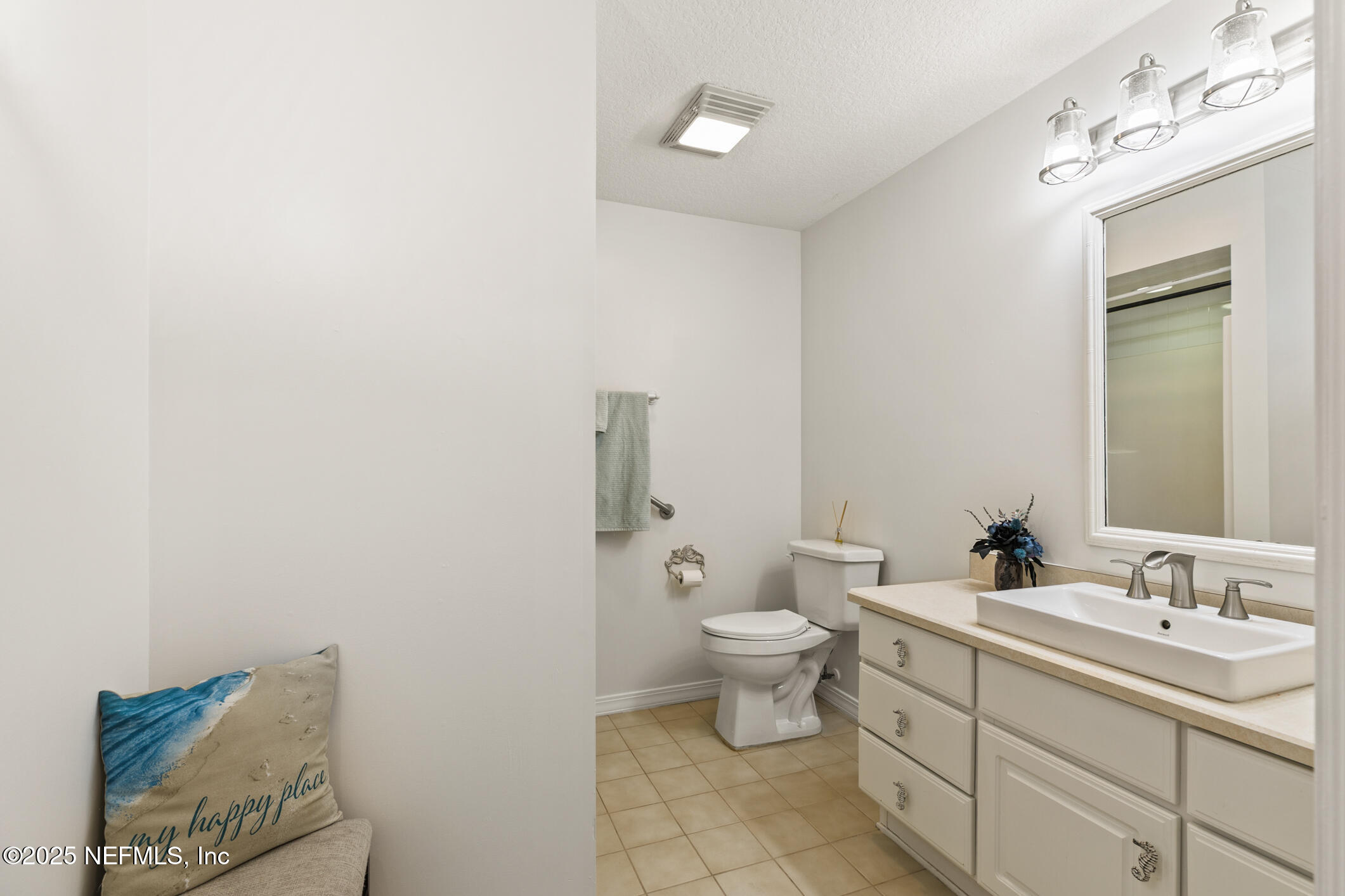120 Stokes Landing Road St. Augustine, FL 32095 - Photo 33 of 78 a bathroom with a toilet sink double vanity and mirror