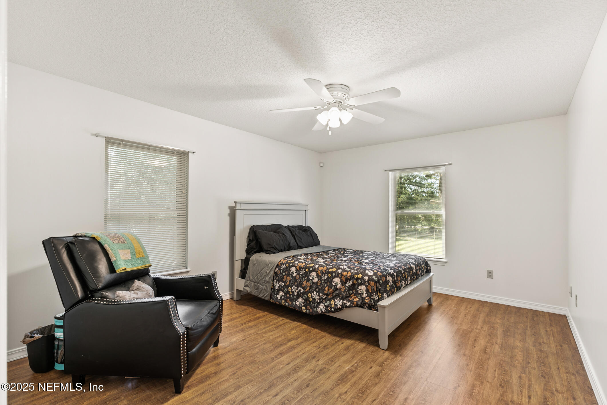 120 Stokes Landing Road St. Augustine, FL 32095 - Photo 37 of 78 a bedroom with a bed a couch and a window