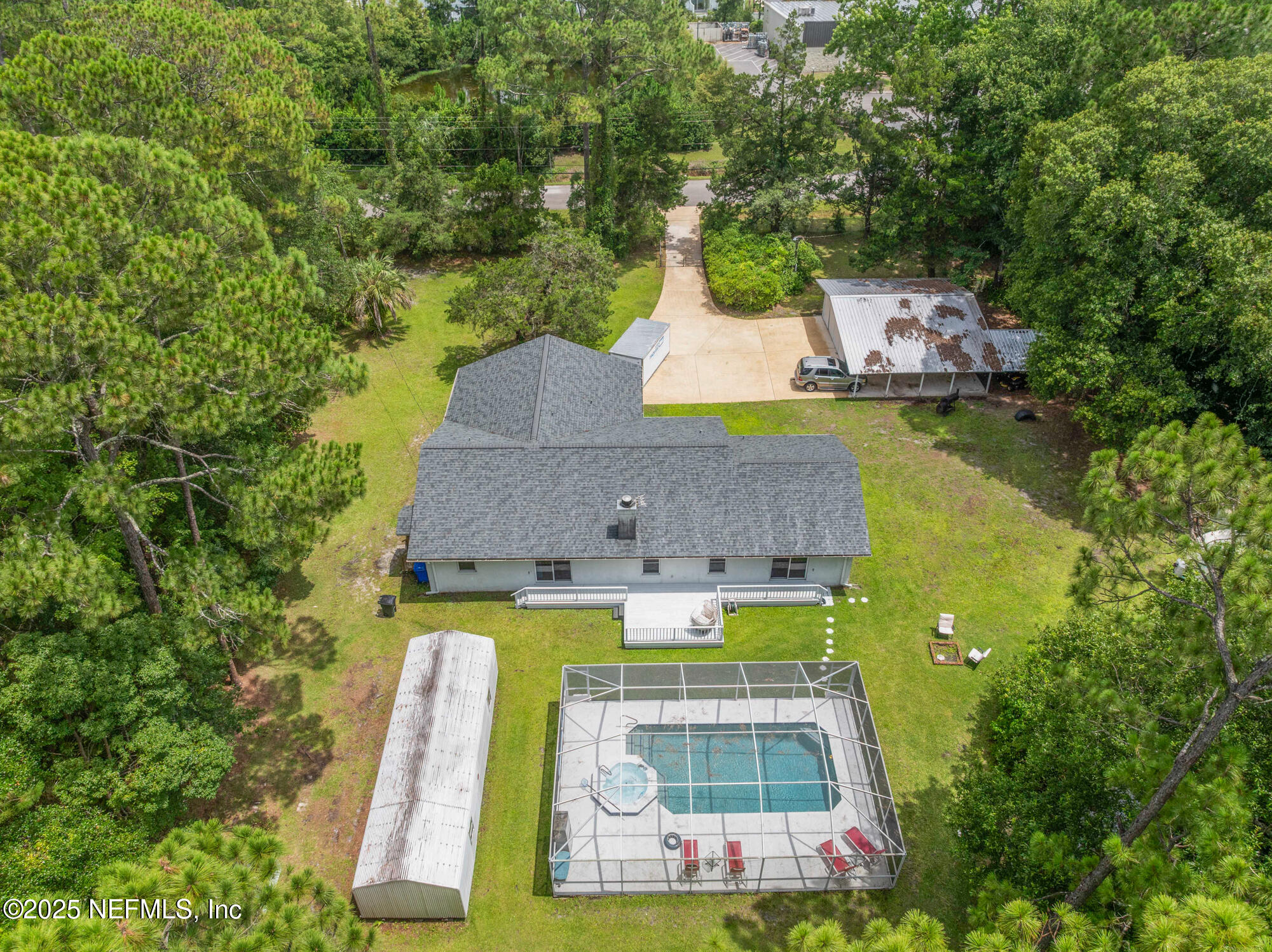 120 Stokes Landing Road St. Augustine, FL 32095 - Photo 70 of 78 an aerial view of a house with swimming pool and large trees