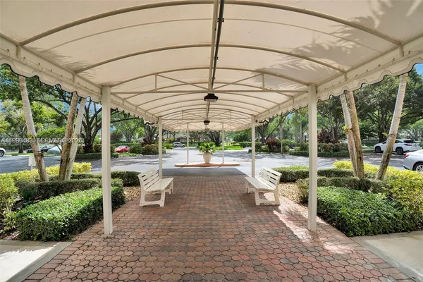 a view of a patio with table and chairs under an umbrella