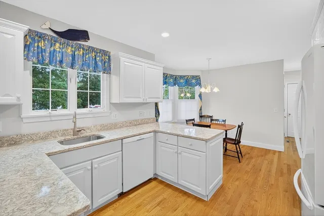 a kitchen with a sink cabinets and window
