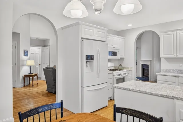 a kitchen with stainless steel appliances granite countertop a refrigerator a stove and a sink with large countertops