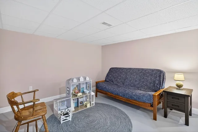 a living room with a couch and a dining table