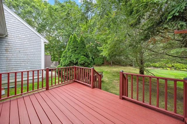 a balcony with wooden floor and fence