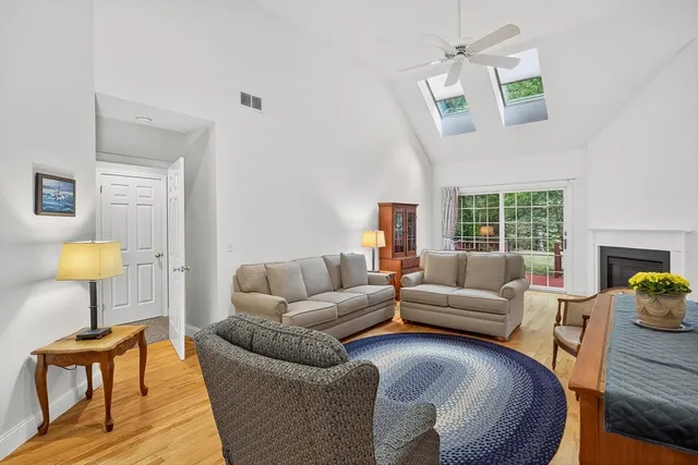 a living room with furniture a window and a chandelier