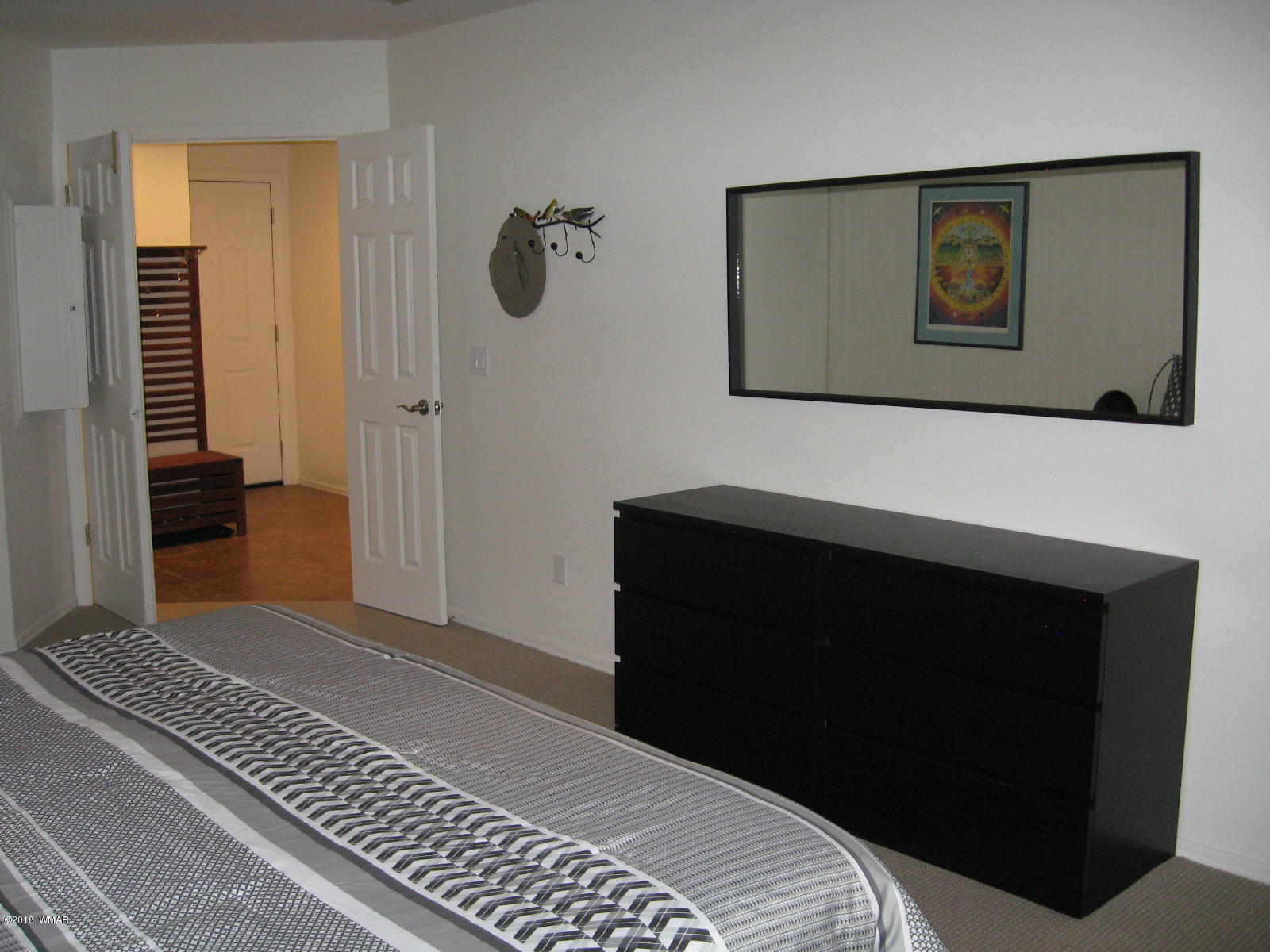 4639 Buck Springs Road Pinetop, AZ 85935 - Photo 12 of 19 a bedroom with a bed and a wall painting