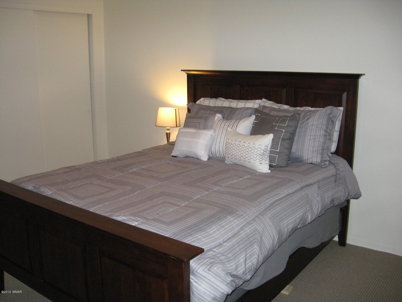 4639 Buck Springs Road Pinetop, AZ 85935 - Photo 15 of 19 a bedroom with a bed and a night stand