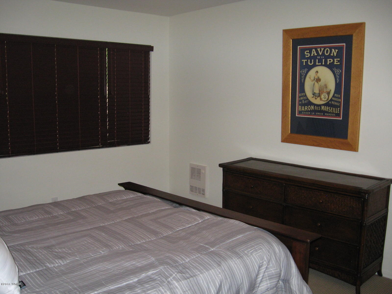 4639 Buck Springs Road Pinetop, AZ 85935 - Photo 16 of 19 a bedroom with a bed and painting on the wall