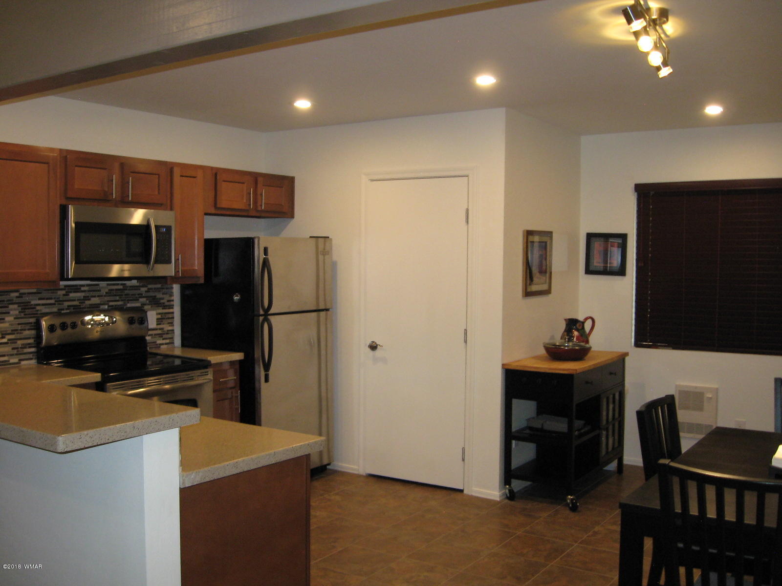 4639 Buck Springs Road Pinetop, AZ 85935 - Photo 5 of 19 a kitchen that has a sink stainless steel appliances a refrigerator and a stove