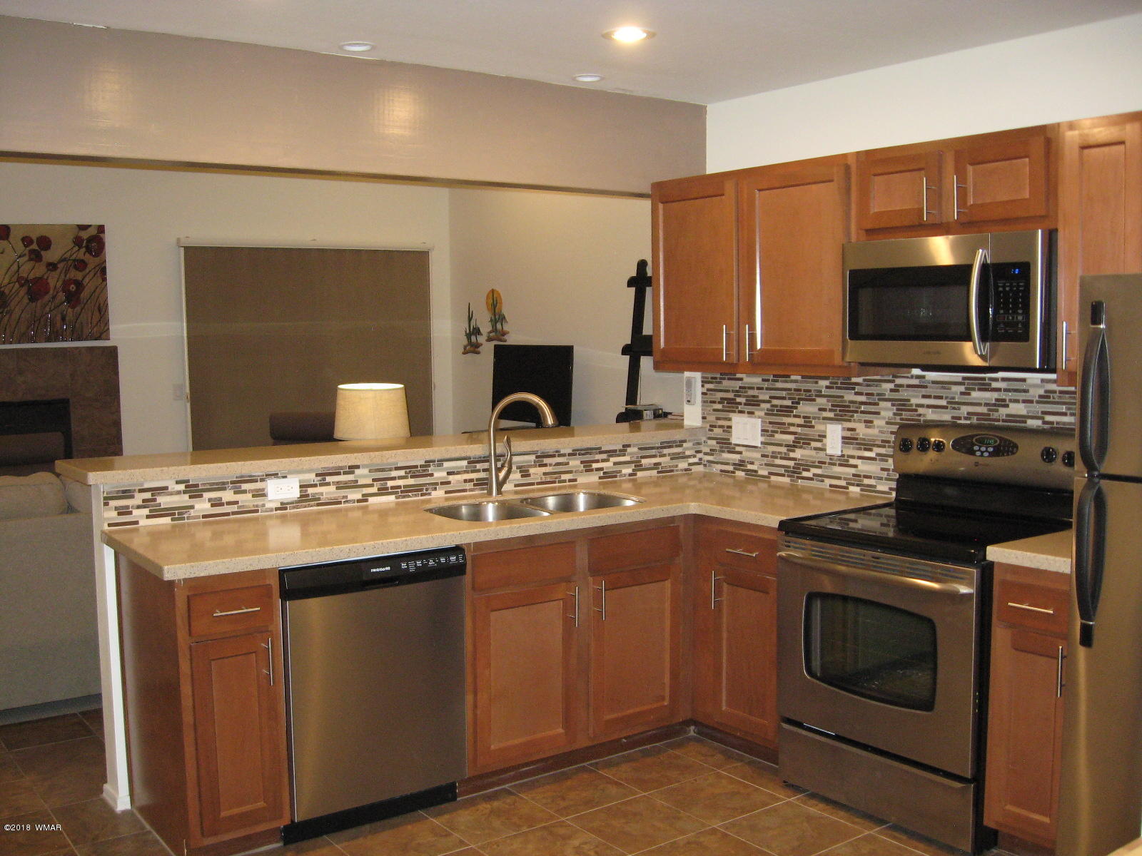 4639 Buck Springs Road Pinetop, AZ 85935 - Photo 7 of 19 a kitchen with stainless steel appliances granite countertop a stove and a sink