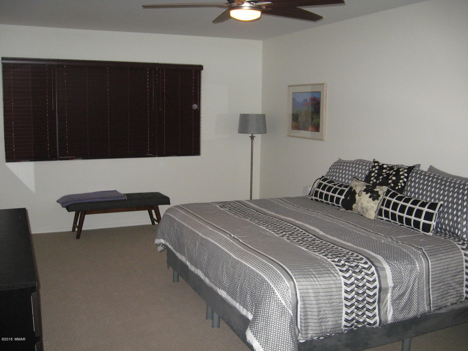 4639 Buck Springs Road Pinetop, AZ 85935 - Photo 10 of 19 a bedroom with a bed and a chair