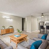 a living room with furniture and kitchen view