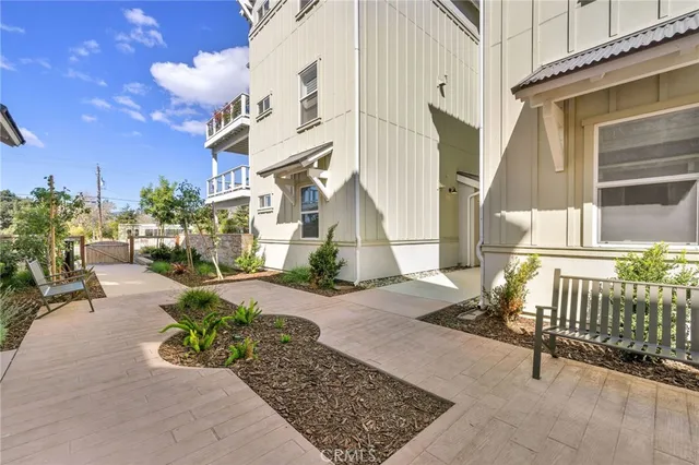 front view of a house with a chairs and table in a patio