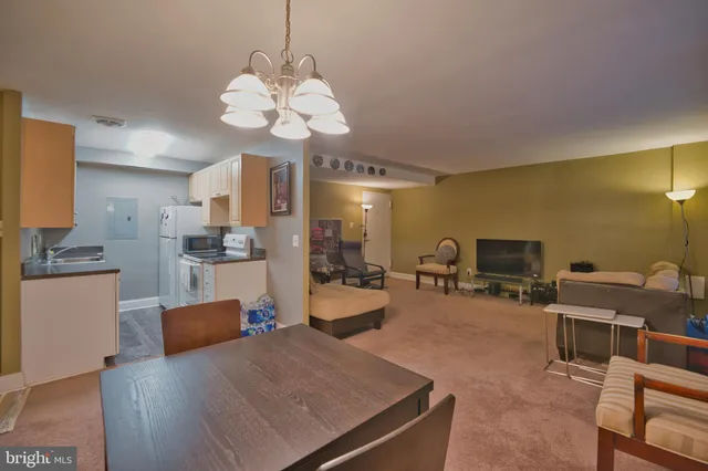 a view of a dining room with furniture and chandelier