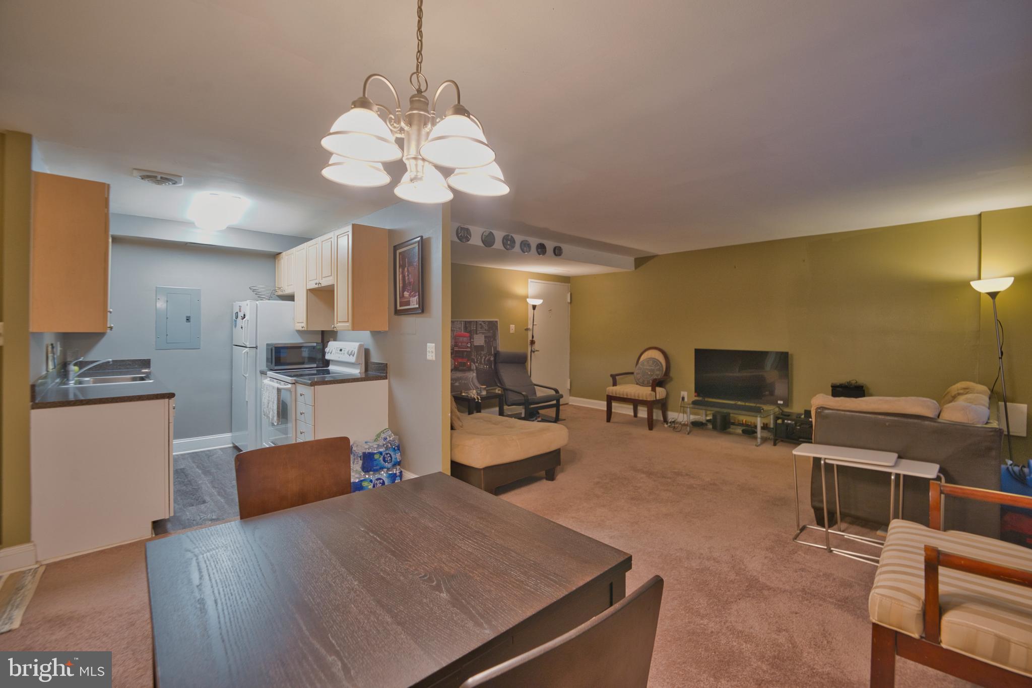 1005 Chillum Road, Unit 117 Hyattsville, MD 20782 - Photo 12 of 16 a view of a dining room with furniture and chandelier