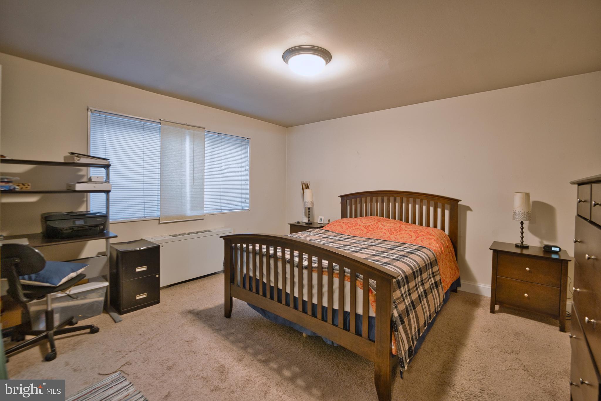 1005 Chillum Road, Unit 117 Hyattsville, MD 20782 - Photo 15 of 16 a bedroom with a bed and a chair